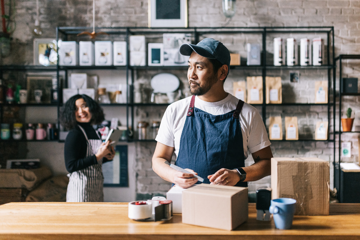 Coffee shop owner packs a box of his freshly roasted coffee